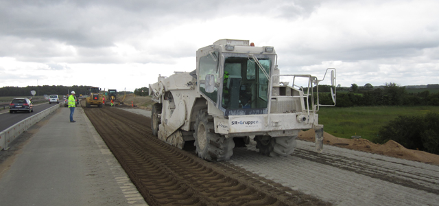 Photo of mixing cement in the widened road section.