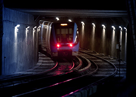 Trains on traintracks in tunnel, blurred